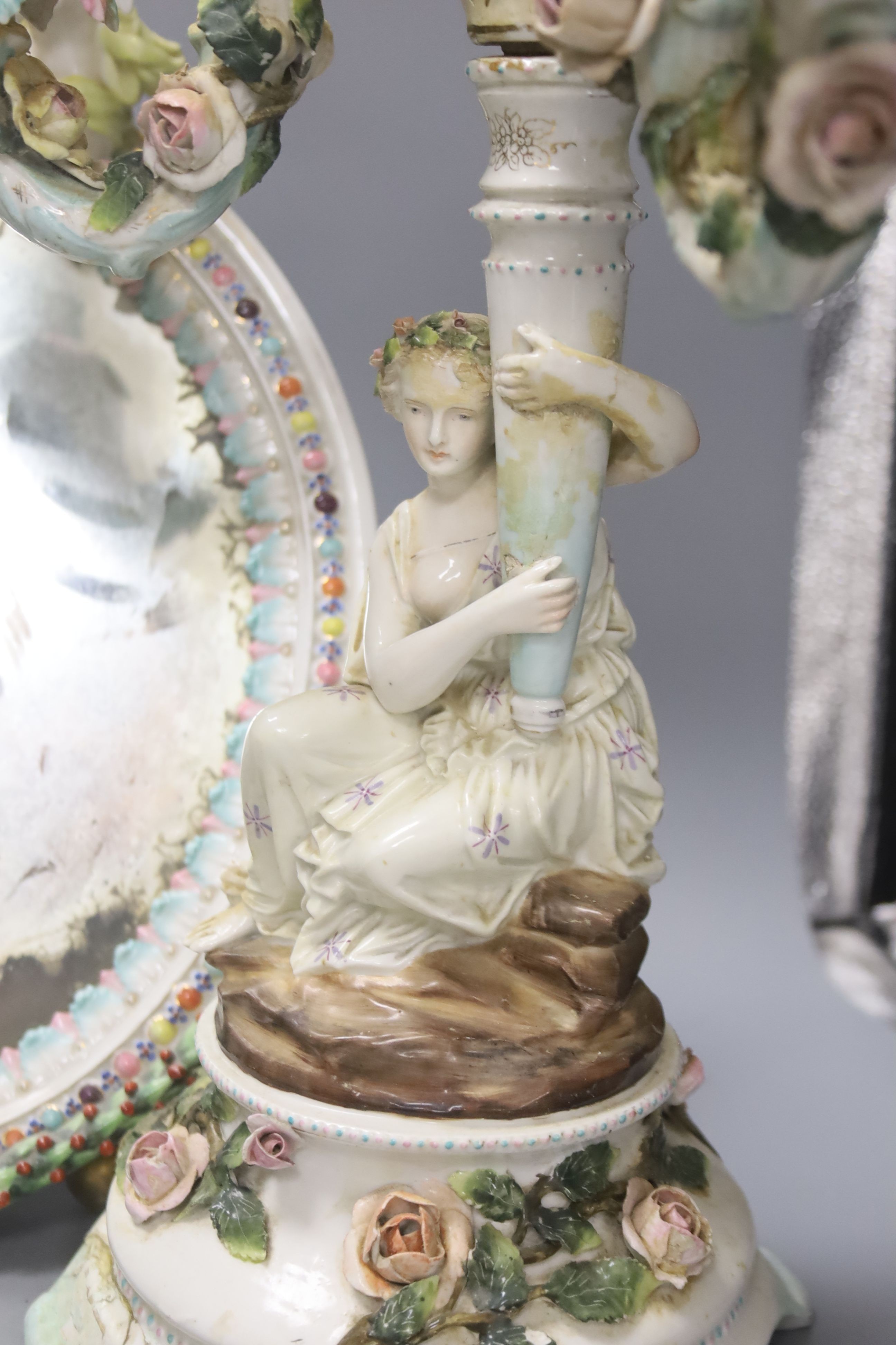 A pair of 19th century Sitzendorf porcelain three branch candelabra (a.f.) and a similar oval porcelain framed easel mirror (3)